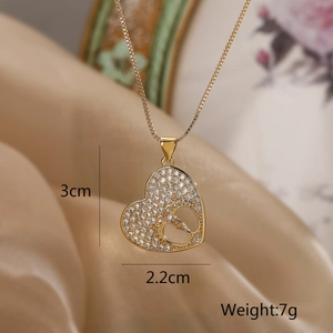 Detail view of gold heart necklace with baby footprints pendant showing 3cm x 2.2cm size