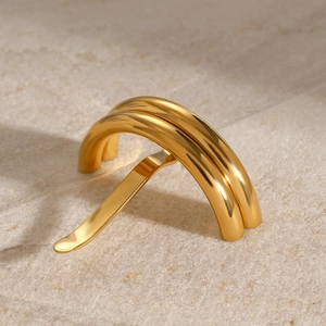 Close-up of golden U-shaped stainless steel hair pin on textured stone background
