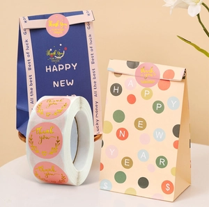 Pink round thank you stickers roll with gold foil text for gift packaging bags