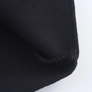 Close-up of premium stitching and knit texture on black halter midi dress fabric