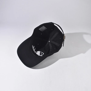 Detailed interior view of a black cotton baseball cap showing neat stitching and size tag