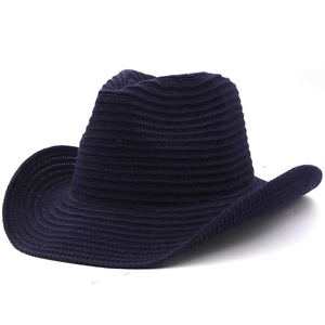 Detailed close-up of navy blue knitted fedora hat showing woven texture and curved brim