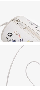 Close-up of white cylinder bag featuring silver zipper and hand-drawn graffiti detail