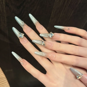 Sparkly silver cat-eye press-on nails with luxury rhinestones on long stiletto shape