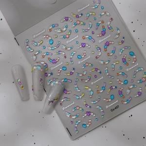 Detail of colorful rhinestone nail stickers Co-407 on light grey glossy nails