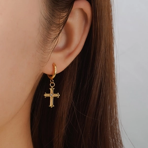 Elegant 18K gold plated cross pendant hoop earrings for women shown on a model