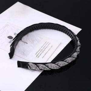 Detailed view of shimmering silver rhinestones and non-slip teeth on the black headband