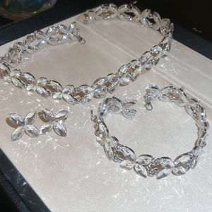 Detail of silver heart-shaped crystal necklace, bracelet and earrings in a gift box