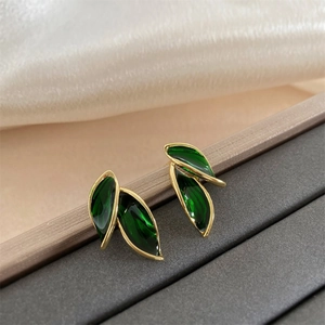 Elegant 925 silver leaf earrings with green enamel inlay and golden metal edges
