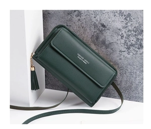 Detail of dark green leather crossbody mini bag with tassel zipper and shoulder strap