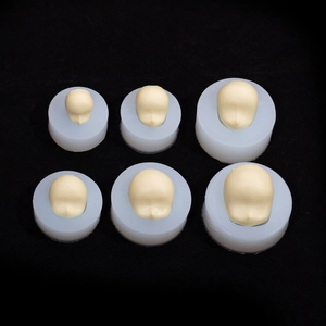 Set of 6 silicone face molds in three sizes for clay doll head making on black background