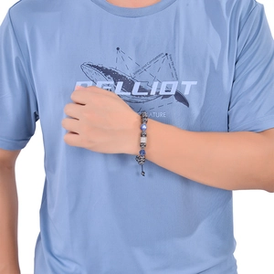 Close-up of 10mm beaded magnetic bracelet with black and blue stones on a male wrist
