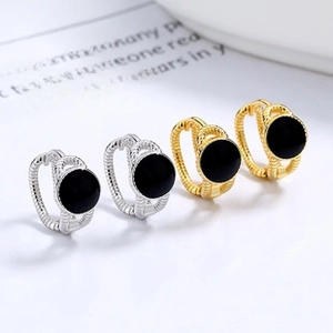 Detailed macro view of 925 sterling silver hoop earrings with black enamel inlay