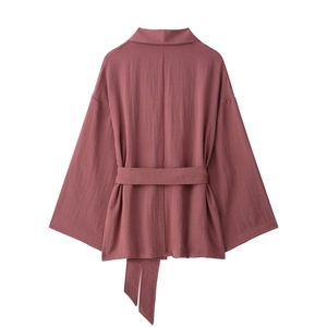 Pink kimono wrap top with wide sleeves and belt seen from the back in linen texture