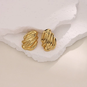 Macro view of 18K gold plated stainless steel stud earrings with irregular ripple texture