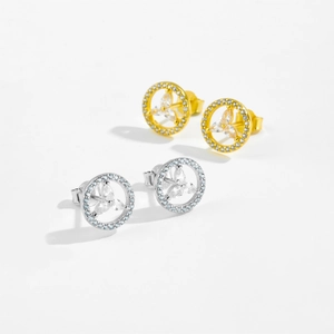 Close-up of gold and silver clover stud earrings with sparkling cubic zirconia inlay