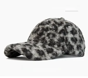 Close-up of grey leopard print baseball cap with soft plush faux fur texture and brim