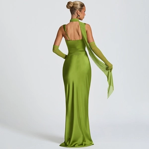 Detailed back view of green satin slim-fit dress with elegant backless design and gloves