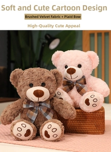 Detail of plush teddy bears with plaid bows and embroidered heart pads in soft lighting