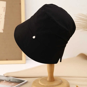 Elegant black cotton bucket hat for women with a silver metal pendant for sun protection