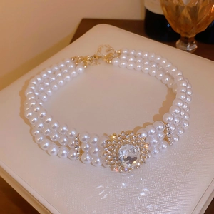 Détail d'un collier de perles à trois rangs avec cristal vintage sur support cuir