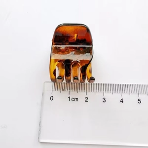Macro view of 2cm amber tortoiseshell hair claw clip with size ruler measurement