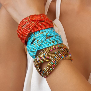 Macro shot of multi-layer bohemian glass seed bead woven bracelets in vibrant mixed colors