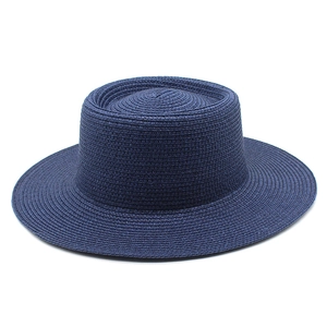Macro view of navy blue wide-brim boater hat featuring high-density woven texture