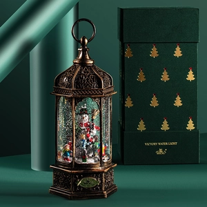 Bronze Christmas lantern with snowman scene and water circulation in a festive gift box