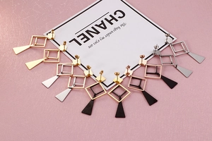 Macro detail of geometric titanium steel earrings in gold silver black and rose gold