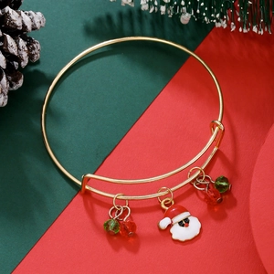 Festive gold adjustable bracelet with Santa pendant and beads on a holiday background