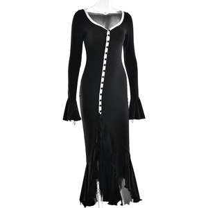 Detail of elegant black dress with white buttons and asymmetric ruffled hemline