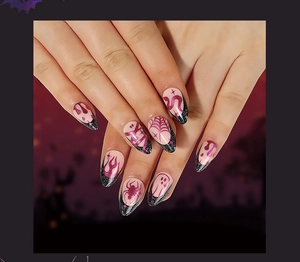 Detail of Halloween press-on nails with black glitter French tips and purple spider web art