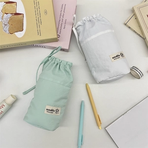 Vertical drawstring stationery pouch in soft green and white for desk storage