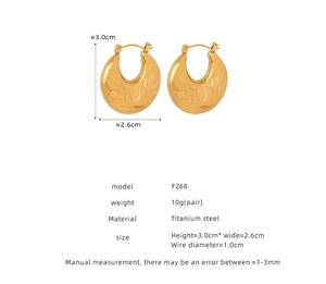 Detail view of gold titanium steel U-shaped earrings with embossed leaf pattern and sizing
