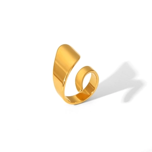 Detailed view of glossy gold spiral open ring featuring a smooth mirror finish