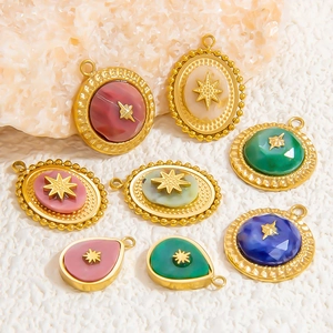 Detailed macro view of bohemian star charms with colorful natural stones and gold metal finish