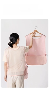 Breathable pink apron with white mesh back design and large front pockets for kitchen use