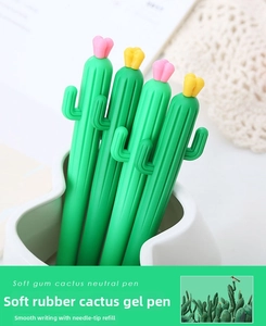 Close-up of green cactus gel pens with pink flower tops in a white pen holder
