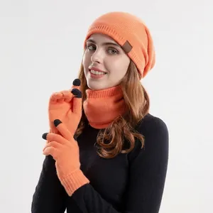 Winter 3-piece set with orange knit beanie, neck warmer, and touch screen gloves for women