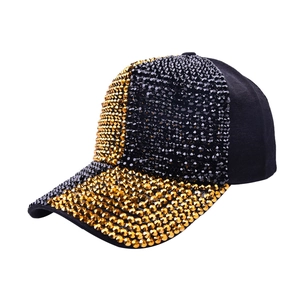 Close-up of black and gold rhinestones on a stylish fashion baseball cap with studs