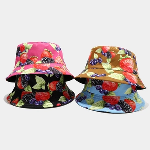 Detail of assorted summer bucket hats with colorful strawberry and berry prints in four colors