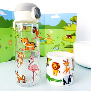 Detail of cartoon animal stickers on a clear water bottle and matching white drinking cup