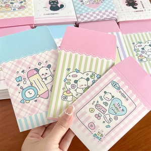 Close-up of pastel paper photo envelopes with cute puppy illustrations and cartoon designs