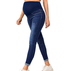 Dark blue maternity skinny jeans with high waist belly support panel shown from a side view