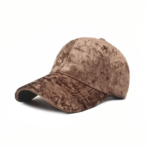 Detail of a dark brown velvet baseball cap showing rich texture and classic six-panel design