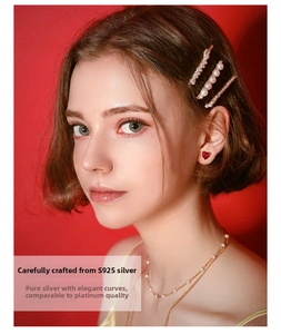 Detailed view of S925 silver necklace and heart earrings with pearls and red stones