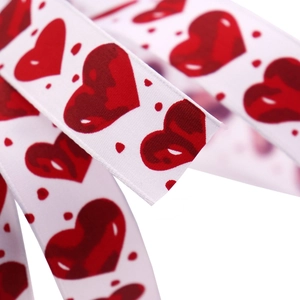 White ribbon with red heart print and polka dots for Valentine gift wrapping