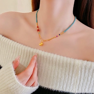 Bohemian gold plated colorful beaded gourd necklace on model with vintage aesthetic