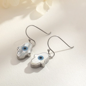 Detail of Hamsa Hand and Evil Eye earrings with silver finish and shell inlay